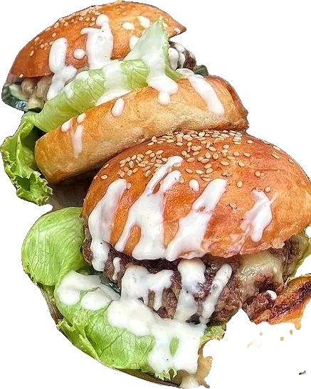 Two Bwibo burgers in sesame buns with lettuce, cheese and white sauce