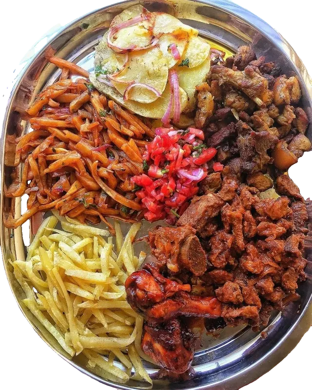 The Nyama Platter: mbuzi, pork, chicken drumsticks, fries, masala fries, Lyonnaise potatoes and kachumbari on a steel tray